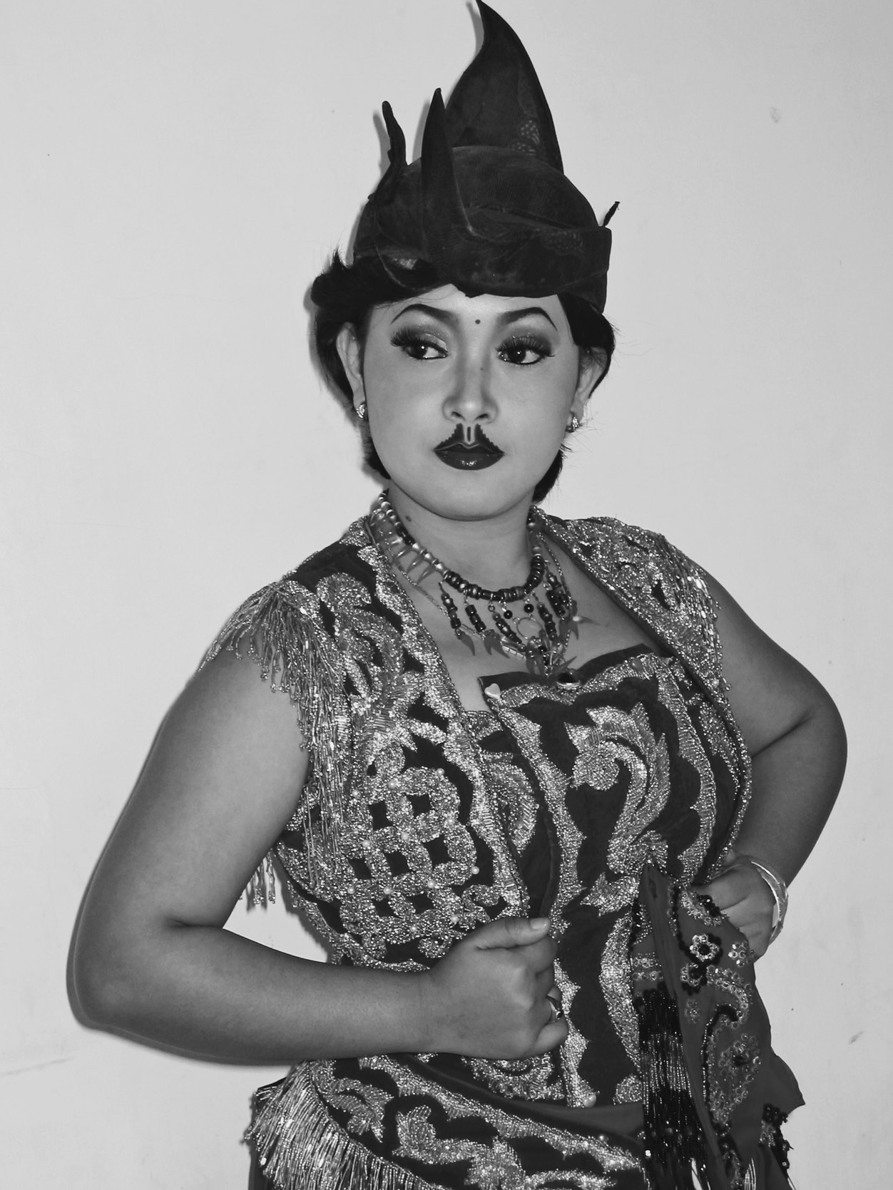 Sri Handayani (a female) models a costume and makeup for Ngremo Tayub. Photograph taken by the author, 2006.