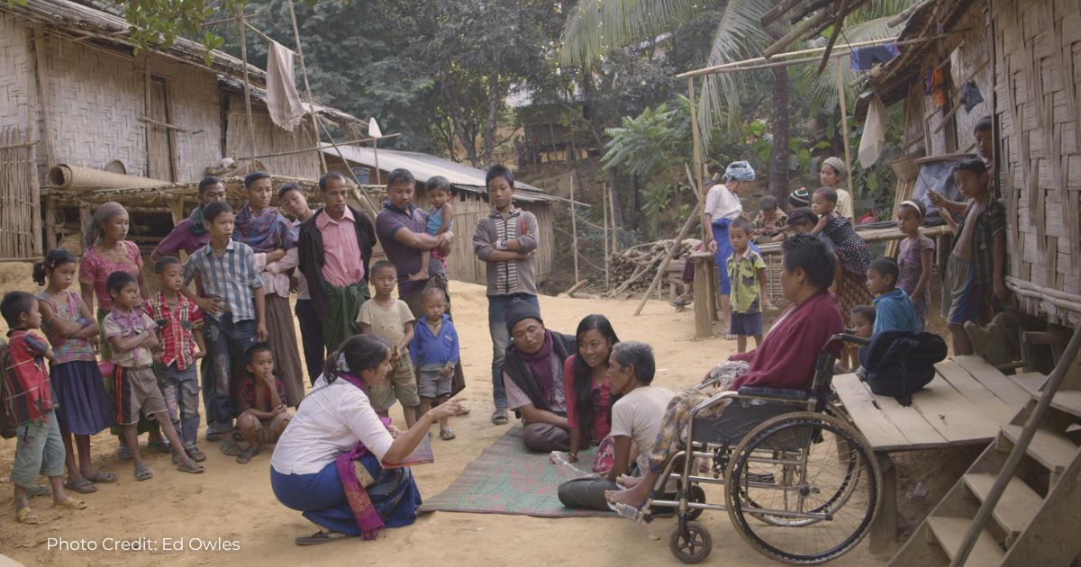 Dr Hoque talking with people from the Marma community