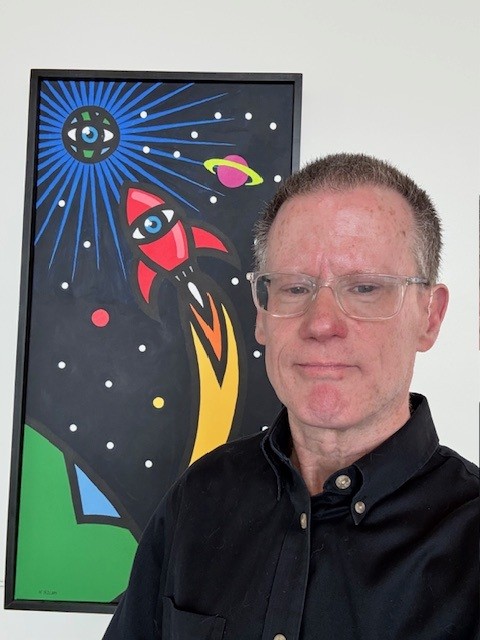 Michael Kane in front of "Mission: Eyeth” by Warren Miller, 2011.